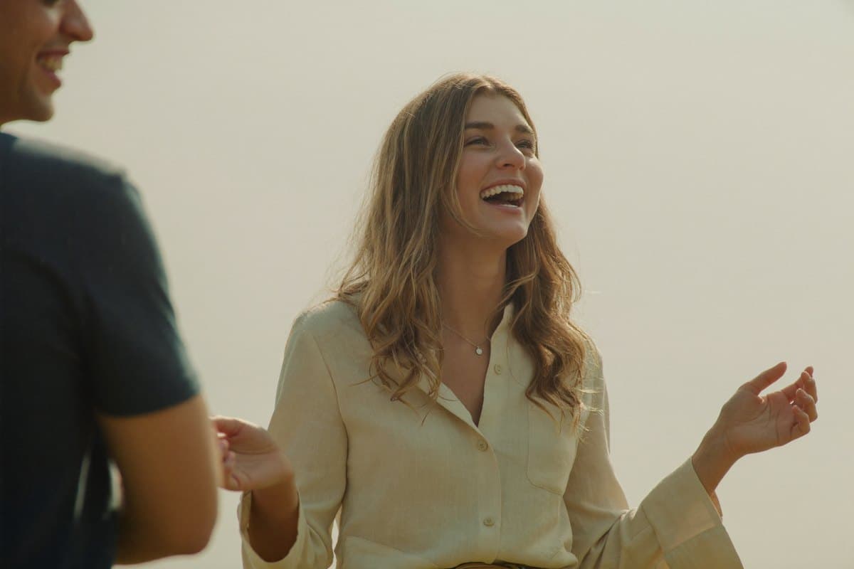 Young woman laughing outdoors in the morning light
